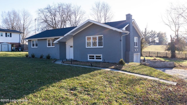 view of front of home with a garage and a front lawn