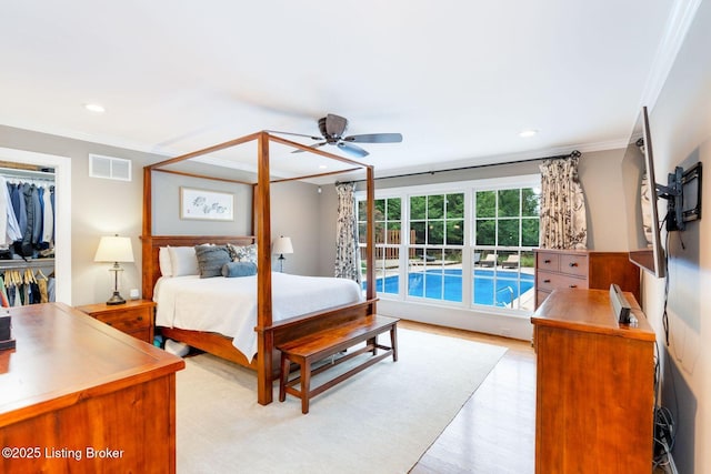 bedroom with light wood-style floors, visible vents, crown molding, and recessed lighting