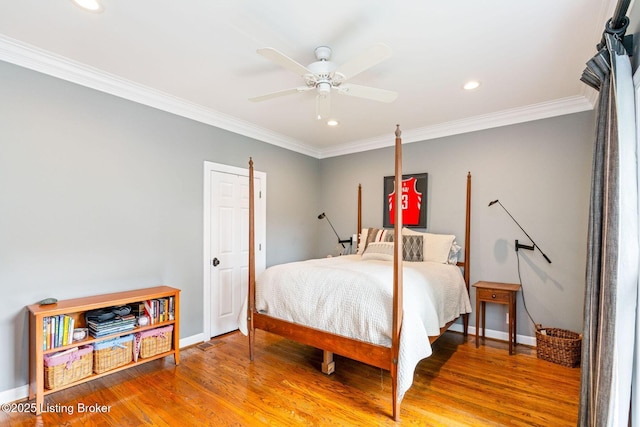 bedroom featuring baseboards, recessed lighting, wood finished floors, and crown molding