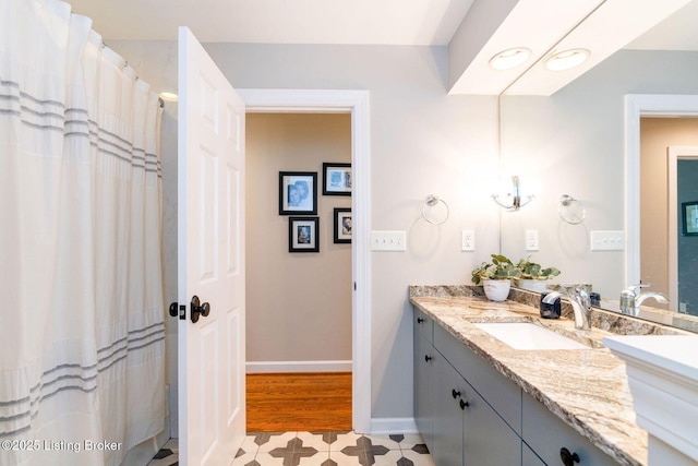 bathroom with baseboards and vanity