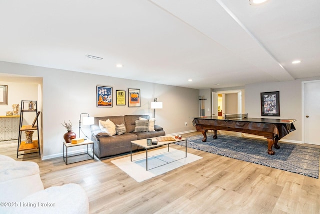 living area with recessed lighting, visible vents, baseboards, and wood finished floors