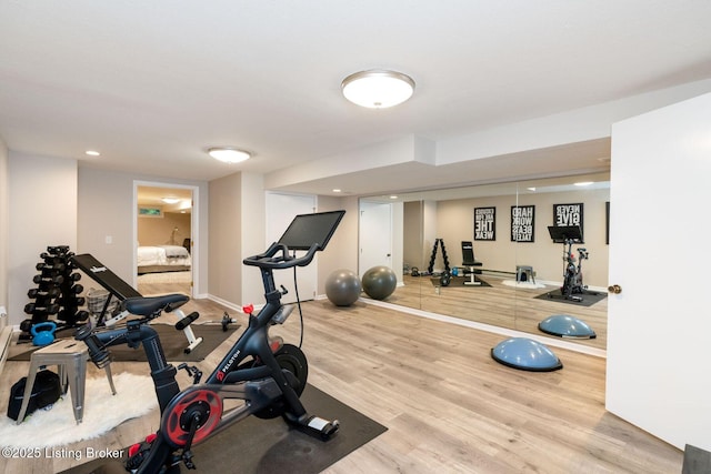 workout room with baseboards and wood finished floors