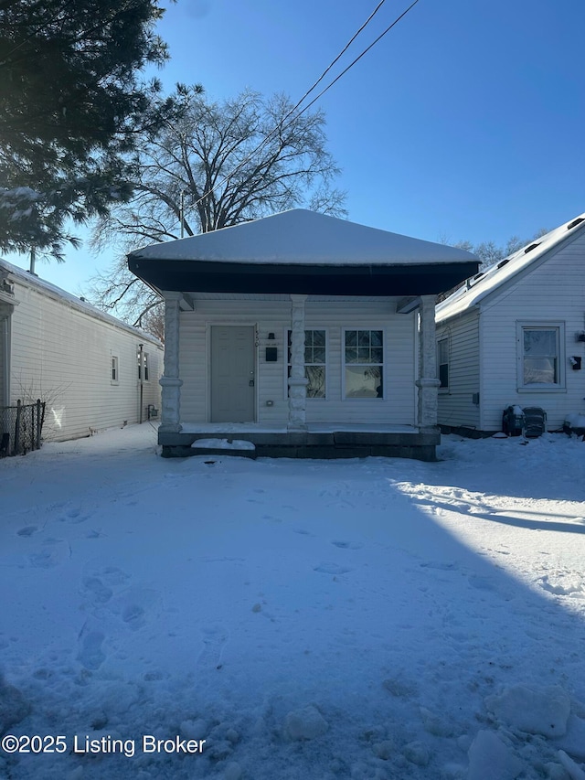 snow covered house with a porch