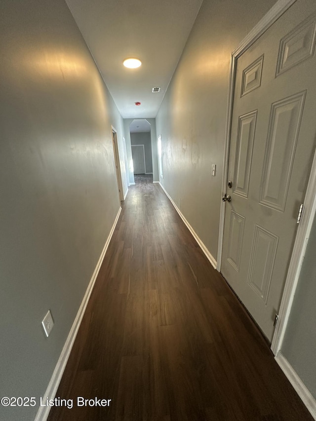 hall with dark hardwood / wood-style floors