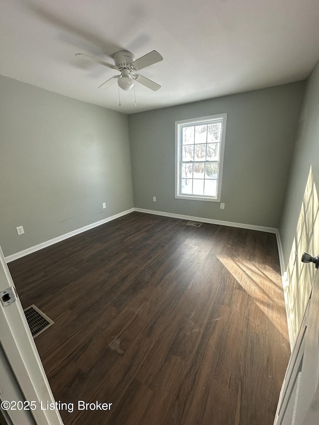 spare room featuring dark hardwood / wood-style flooring and ceiling fan