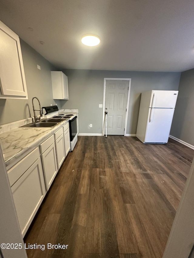 kitchen featuring dark hardwood / wood-style flooring, sink, white cabinets, and white appliances