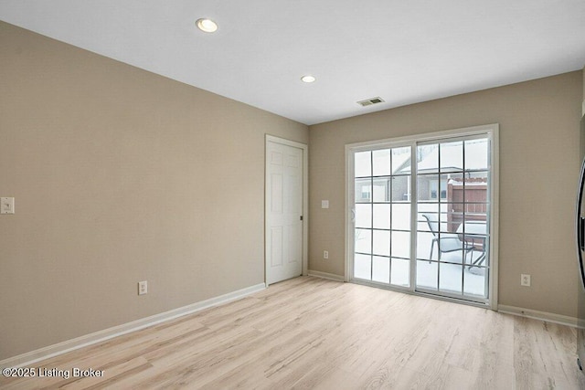 empty room with light hardwood / wood-style floors