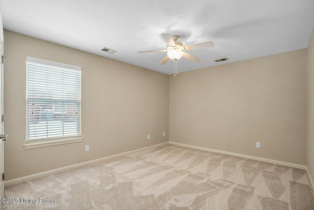 spare room with light carpet and ceiling fan