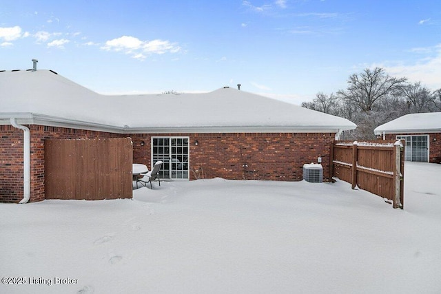 view of snow covered back of property