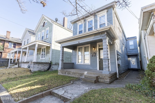 view of front of house featuring covered porch and a front yard