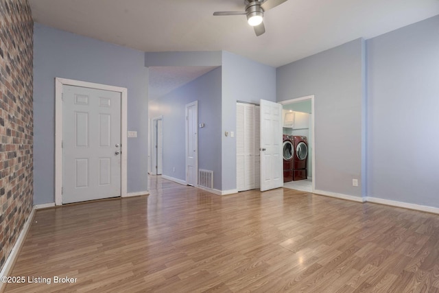 interior space with ceiling fan, wood-type flooring, and independent washer and dryer