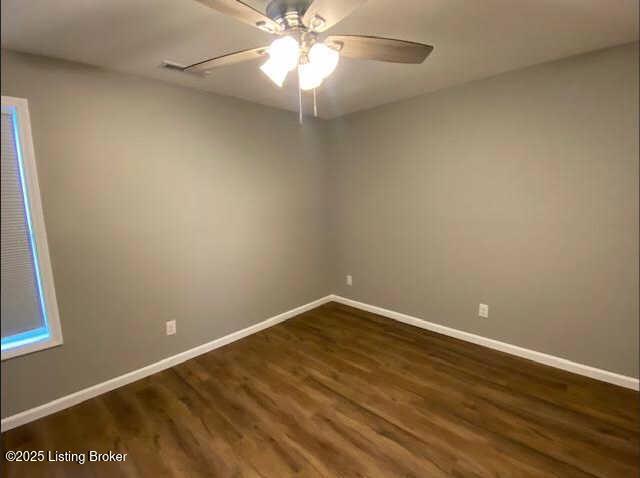 unfurnished room featuring ceiling fan and dark hardwood / wood-style flooring