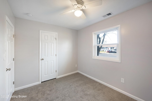 carpeted empty room with ceiling fan