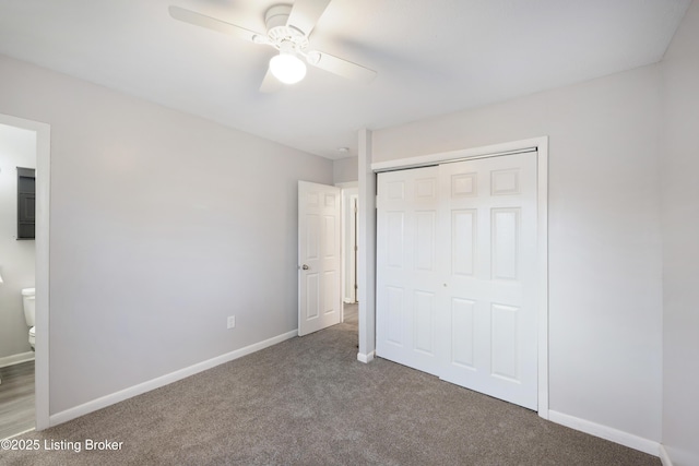 unfurnished bedroom featuring ceiling fan, carpet floors, ensuite bathroom, and a closet