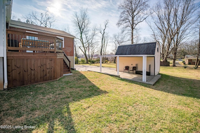 view of yard with a deck, a shed, and a patio area