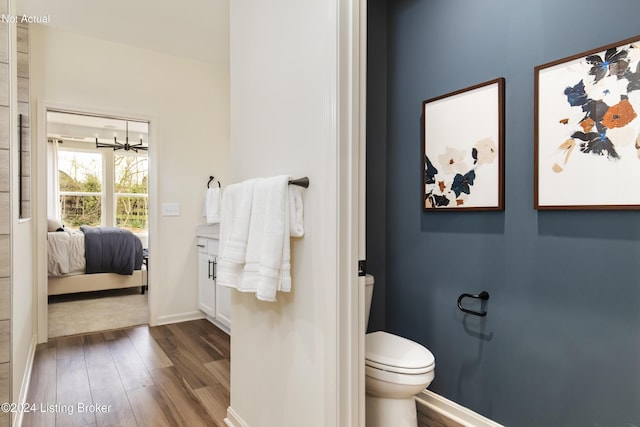 bathroom featuring wood-type flooring, toilet, and ceiling fan