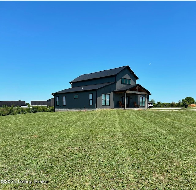 back of house with a lawn