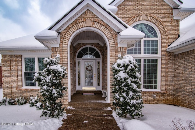 view of snow covered property entrance