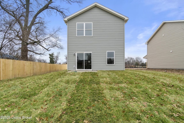 back of house with a lawn