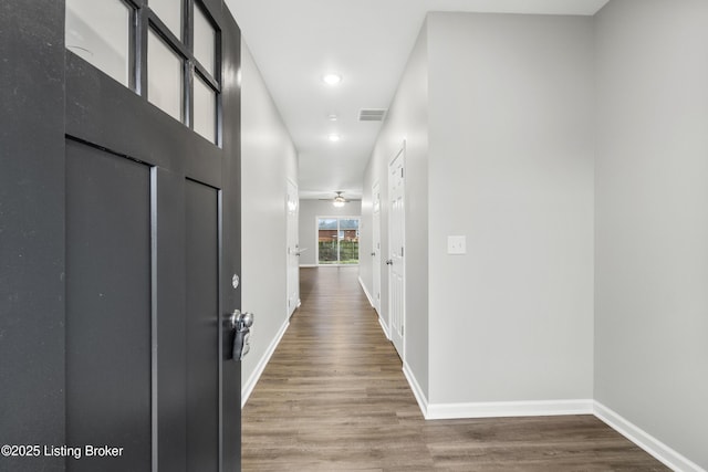 corridor with hardwood / wood-style flooring