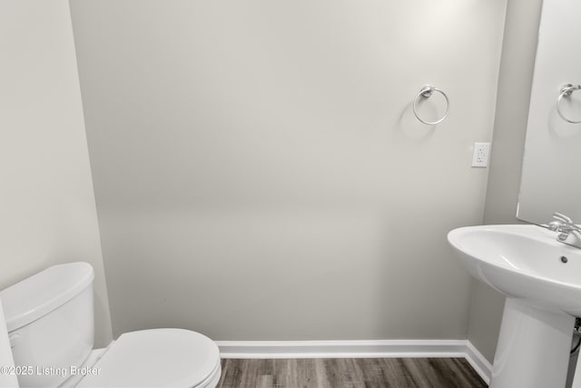 bathroom featuring hardwood / wood-style floors, toilet, and sink