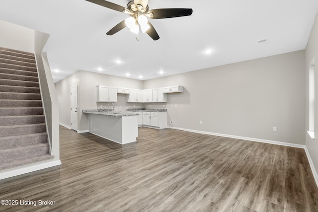 kitchen featuring dark hardwood / wood-style flooring, white cabinetry, sink, and ceiling fan