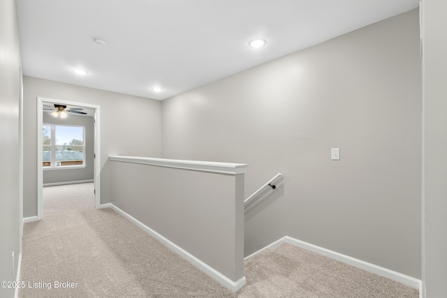 hallway featuring light carpet