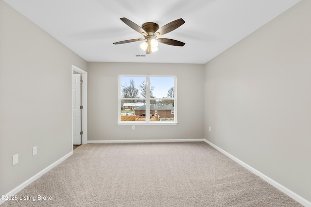 carpeted empty room featuring ceiling fan