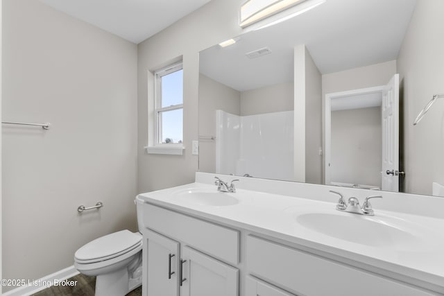 bathroom with a shower, wood-type flooring, vanity, and toilet