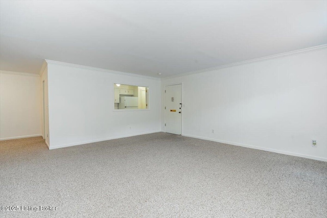 empty room featuring carpet flooring and ornamental molding