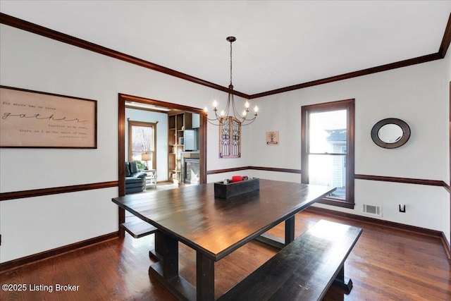 unfurnished dining area with a chandelier, dark hardwood / wood-style floors, and a healthy amount of sunlight