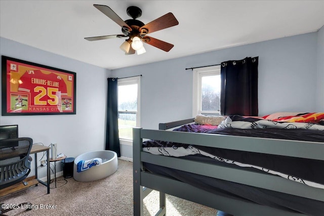 carpeted bedroom with multiple windows and ceiling fan