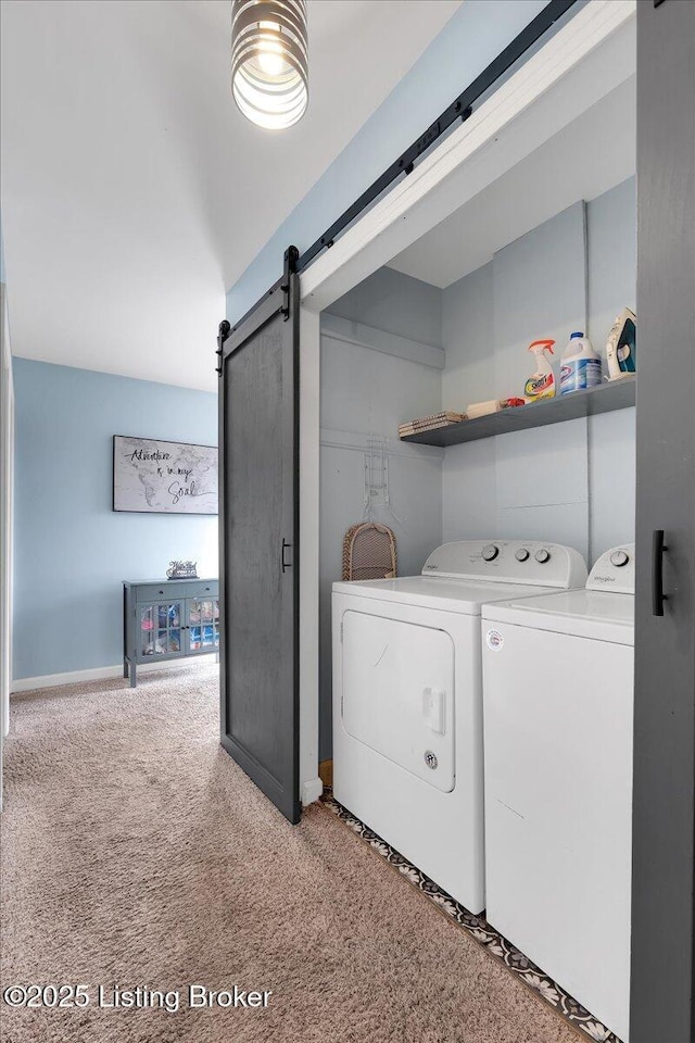 washroom with a barn door, separate washer and dryer, and carpet floors