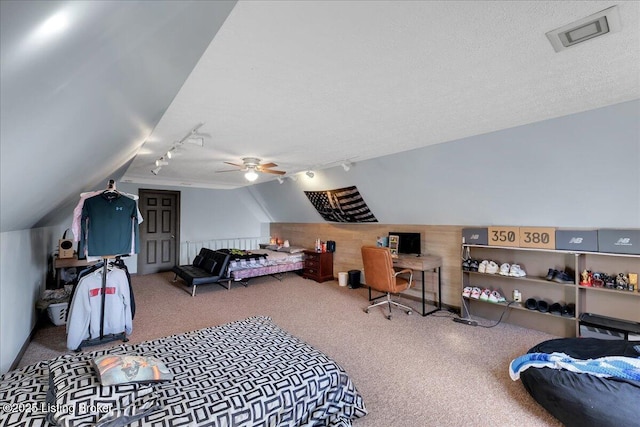 bedroom with carpet, ceiling fan, a textured ceiling, and vaulted ceiling