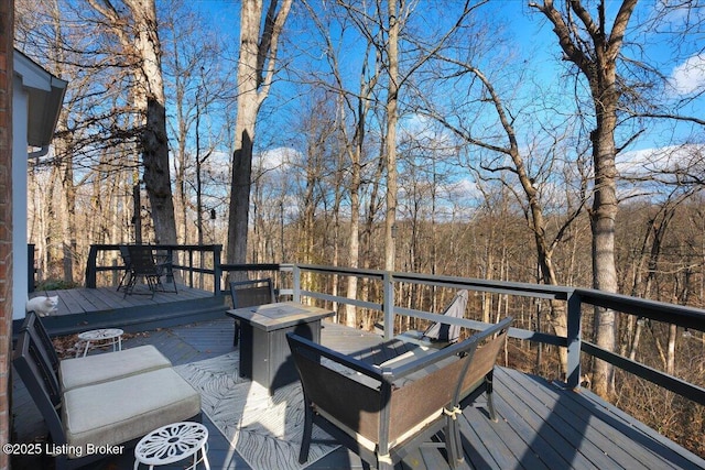 wooden terrace featuring a fire pit