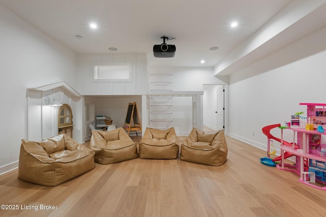 home theater room with hardwood / wood-style flooring