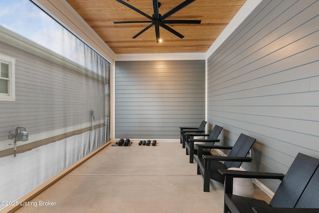 sunroom / solarium featuring ceiling fan and wood ceiling