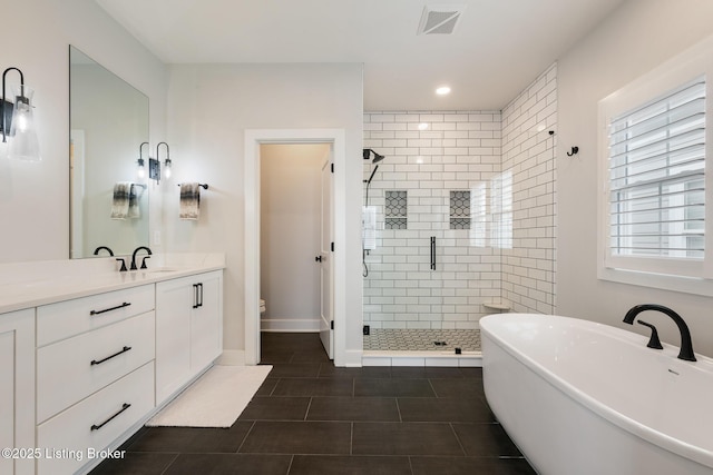 full bathroom featuring toilet, vanity, tile patterned floors, and independent shower and bath