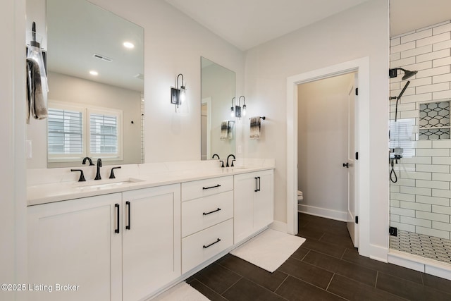 bathroom featuring walk in shower, vanity, and toilet