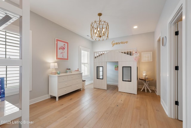 bedroom featuring light hardwood / wood-style floors and an inviting chandelier