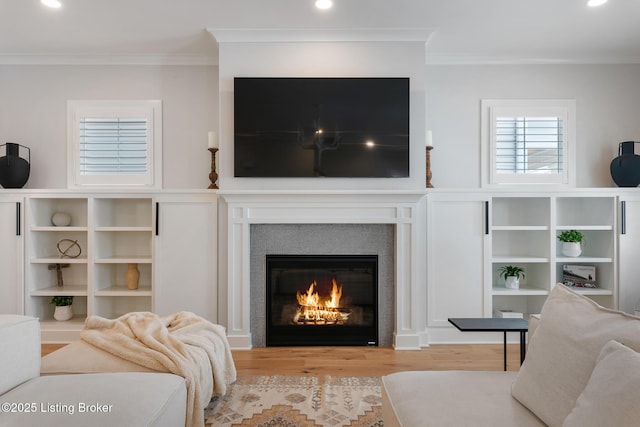 living room featuring light wood-type flooring and crown molding