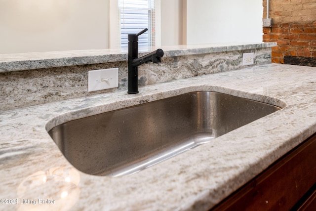 details with light stone countertops and sink