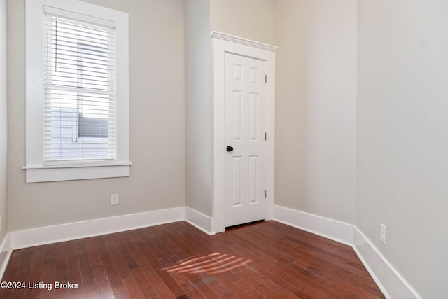 spare room featuring dark hardwood / wood-style flooring