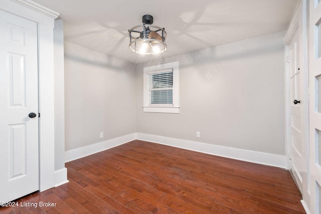 spare room with dark wood-type flooring