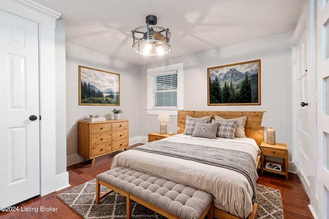 bedroom with dark hardwood / wood-style floors