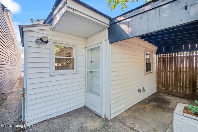 view of exterior entry featuring a carport