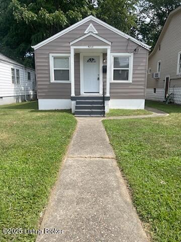 bungalow-style home with a front lawn