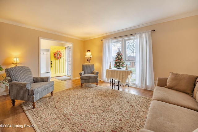 living room with light hardwood / wood-style floors and ornamental molding