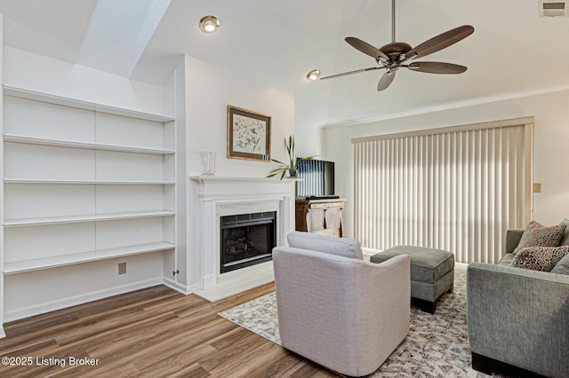 living room with ceiling fan and wood-type flooring