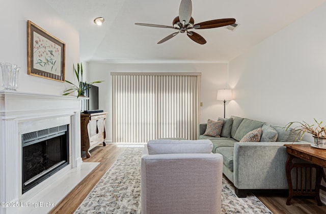 living room with vaulted ceiling, hardwood / wood-style floors, and ceiling fan